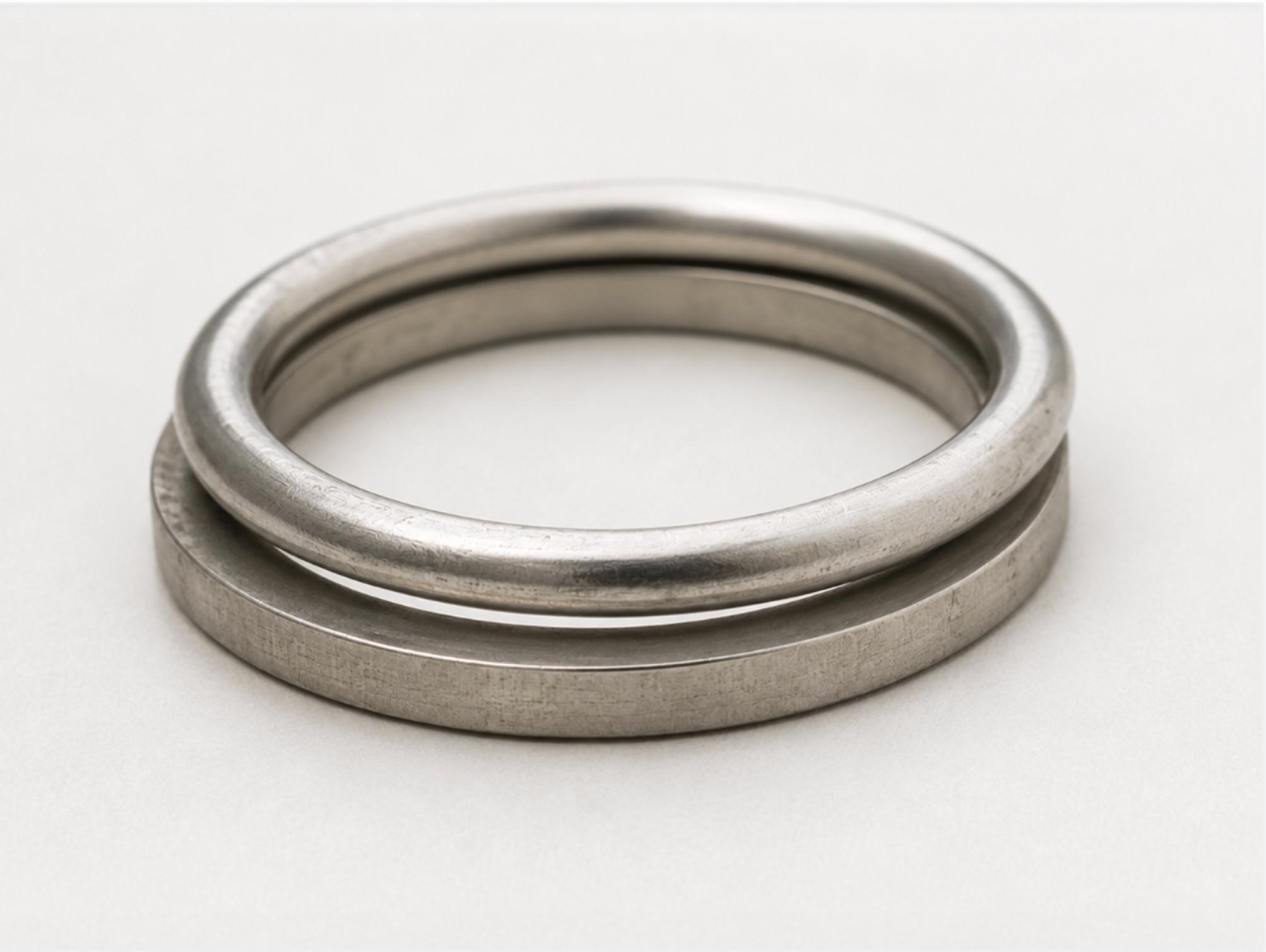 Two sterling silver rings stacked with a shadow gap